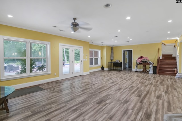 living room featuring stairs, ceiling fan, wood finished floors, and baseboards