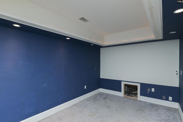 carpeted cinema room with a raised ceiling, recessed lighting, visible vents, and baseboards