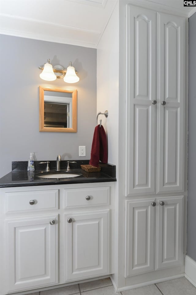 bathroom with tile patterned floors, vanity, and baseboards