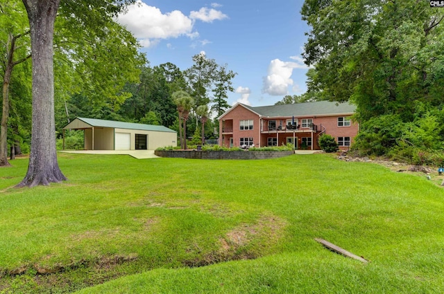 view of yard featuring a deck, a detached garage, and an outbuilding
