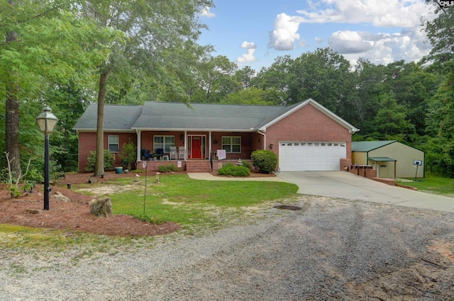 ranch-style home featuring covered porch, brick siding, a garage, and driveway