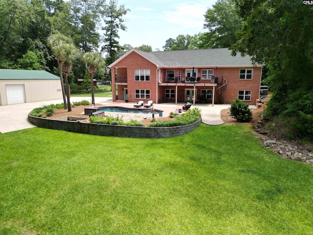 back of property with a lawn, an outdoor structure, a patio area, and a wooden deck