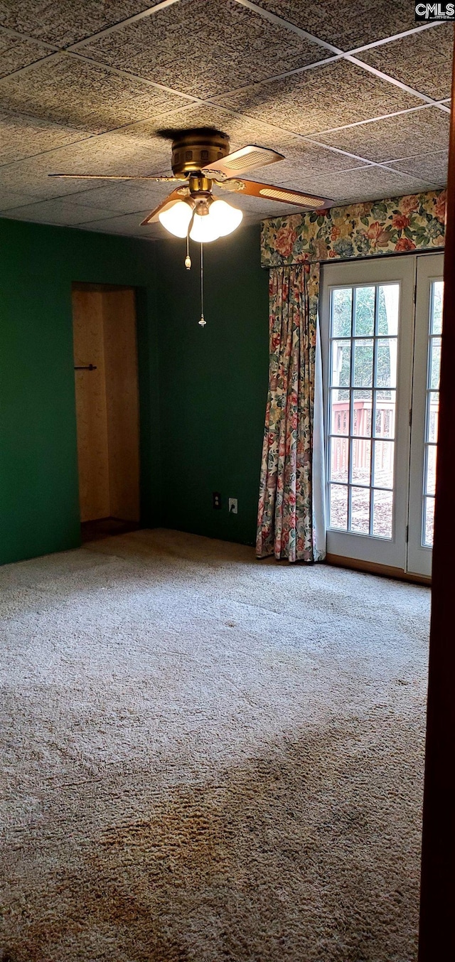 unfurnished room with carpet flooring and ceiling fan