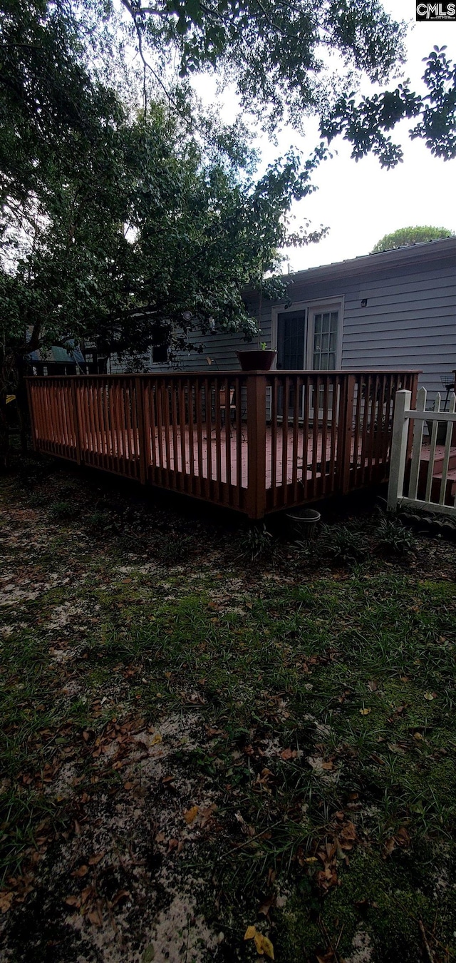 rear view of property featuring a wooden deck