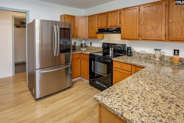 kitchen featuring light stone counters, under cabinet range hood, electric range, light wood-type flooring, and smart refrigerator