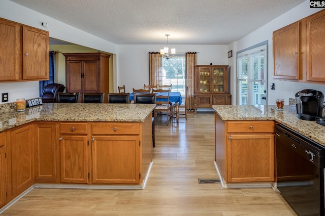 kitchen with dishwasher, a peninsula, hanging light fixtures, and brown cabinetry