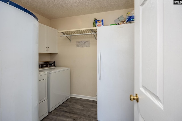 laundry room with a textured ceiling, baseboards, cabinet space, dark wood-style floors, and washer and clothes dryer