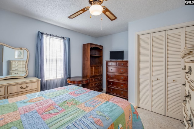 bedroom featuring a textured ceiling, a closet, and a ceiling fan