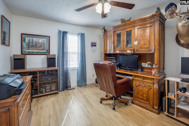 office area with ceiling fan, a textured ceiling, and light wood-style flooring