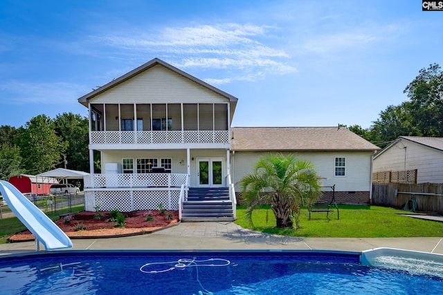 back of property with a yard, a sunroom, fence, and crawl space