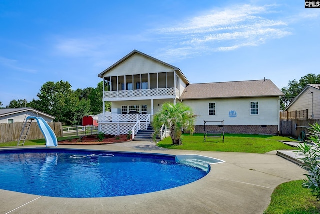 view of swimming pool featuring stairs, a sunroom, a fenced in pool, and a water slide