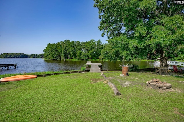 view of yard featuring a water view and a boat dock