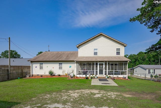 rear view of house with a yard, crawl space, a fenced backyard, and a sunroom