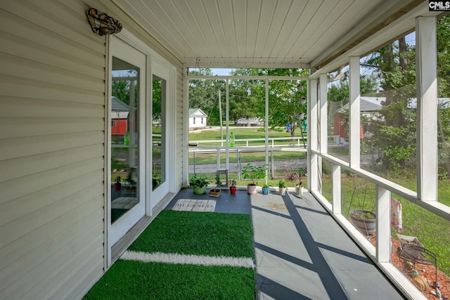 unfurnished sunroom with wooden ceiling