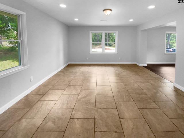 unfurnished room with light tile patterned floors, visible vents, baseboards, and recessed lighting