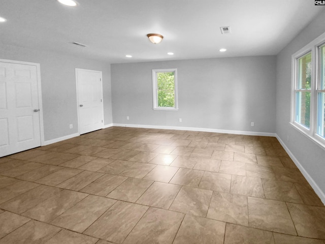 spare room with a wealth of natural light, visible vents, baseboards, and recessed lighting