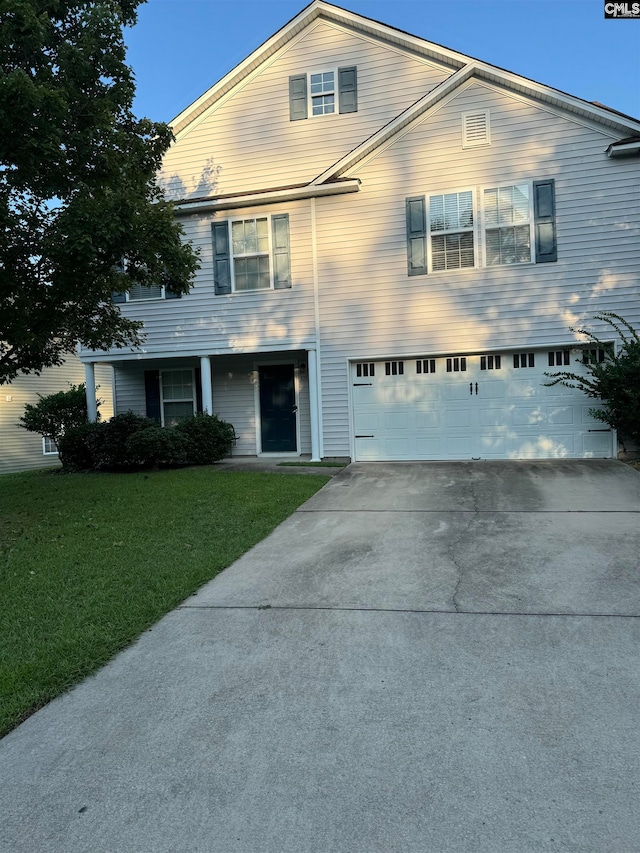 front of property featuring a garage and a front yard