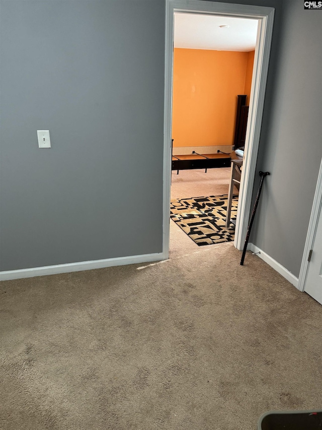 interior space featuring carpet and baseboards