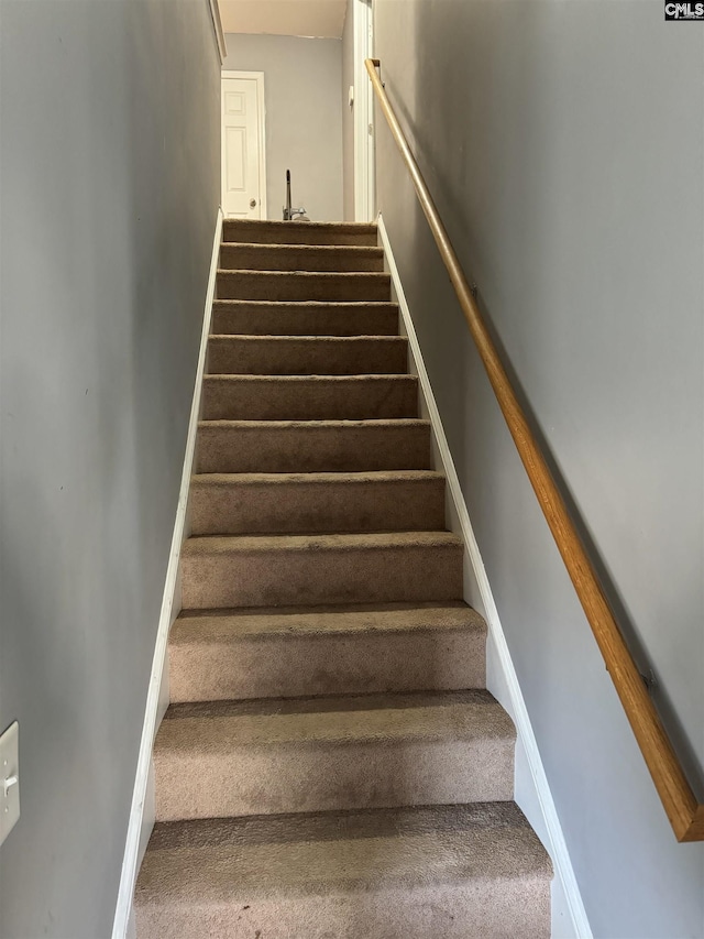 staircase featuring baseboards