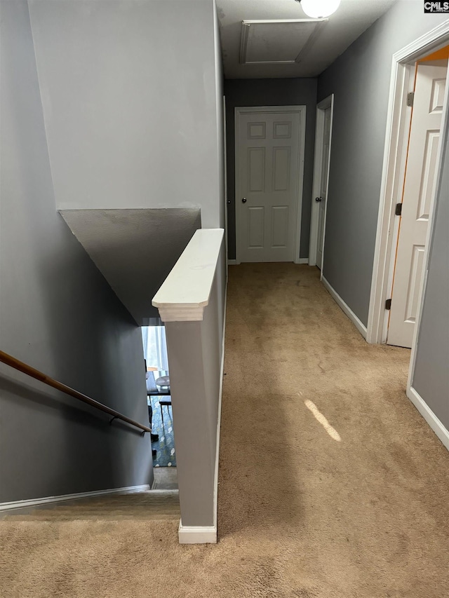 corridor with light colored carpet and baseboards