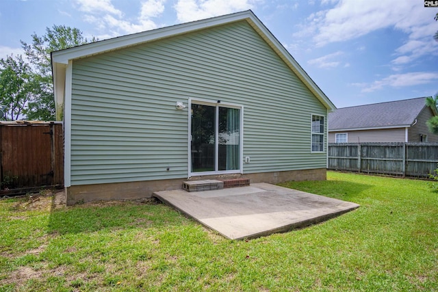 back of property with a patio and a lawn