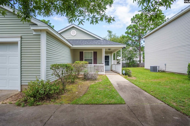 bungalow-style house featuring a garage, a front yard, central AC, and covered porch