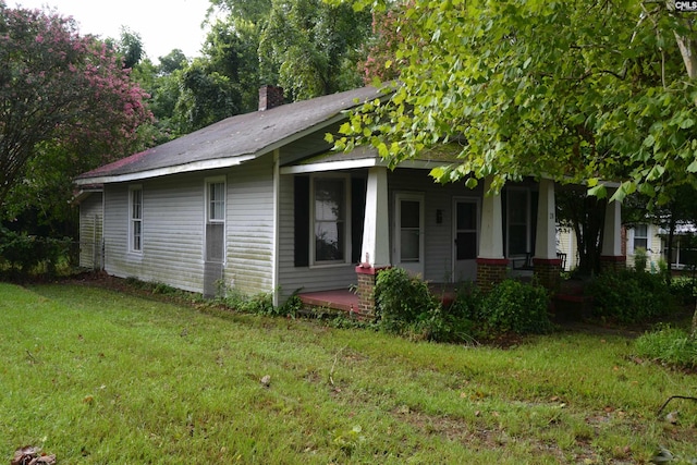 view of front of property featuring covered porch and a front yard