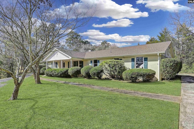 single story home featuring a front yard and brick siding