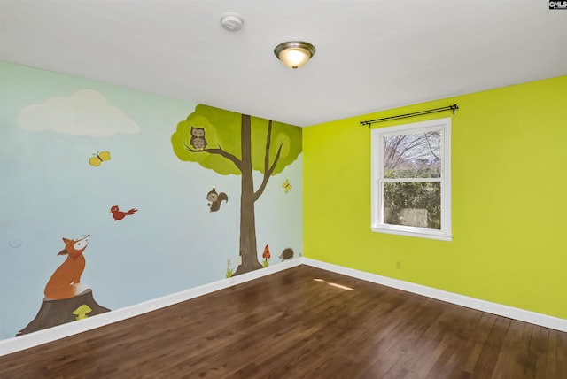 unfurnished room featuring wood finished floors and baseboards