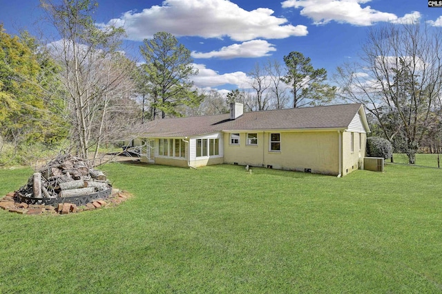 back of property featuring a lawn and a chimney