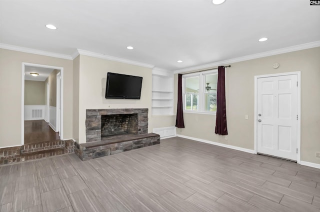 unfurnished living room with baseboards, visible vents, wood tiled floor, ornamental molding, and a stone fireplace