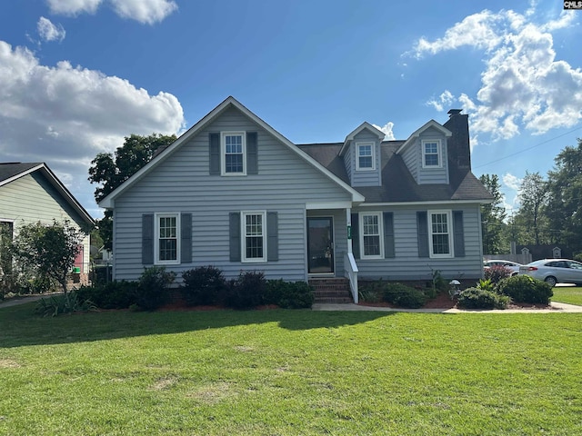 cape cod house with a front yard