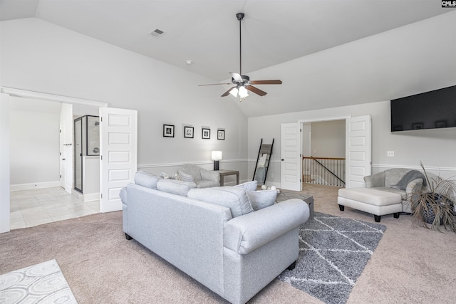 living area with ceiling fan, high vaulted ceiling, light tile patterned flooring, light carpet, and visible vents