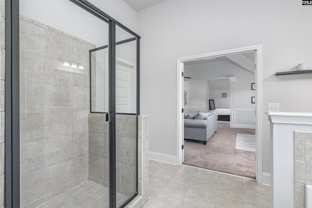 full bath with a stall shower, ensuite bath, baseboards, and tile patterned flooring