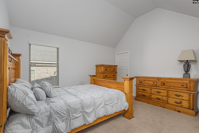 bedroom featuring lofted ceiling and light colored carpet