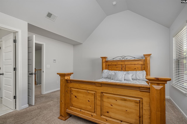 bedroom featuring vaulted ceiling, baseboards, visible vents, and light colored carpet