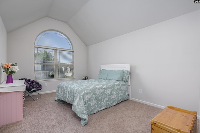 bedroom with lofted ceiling, carpet flooring, and baseboards