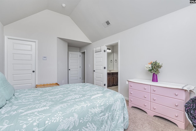 bedroom with vaulted ceiling, light carpet, ensuite bath, and visible vents