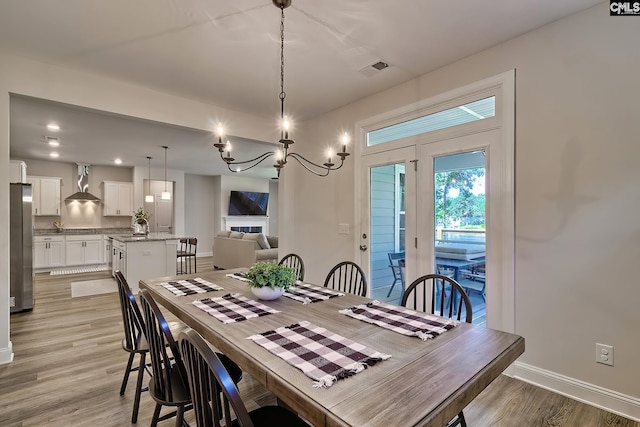 dining room with an inviting chandelier and light hardwood / wood-style floors