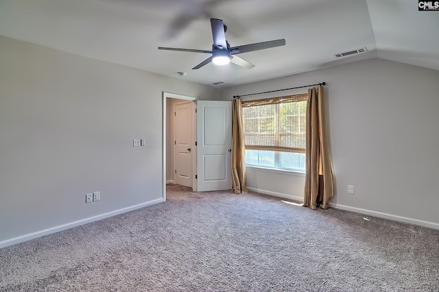 interior space with ceiling fan, light colored carpet, and lofted ceiling