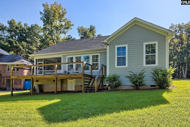 back of property with a yard and a deck