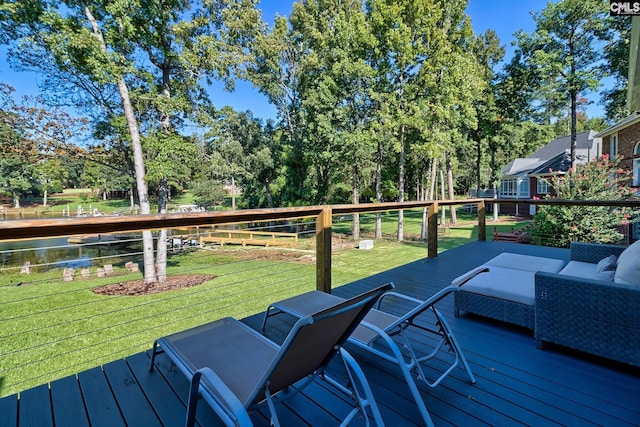 wooden terrace featuring an outdoor hangout area and a lawn