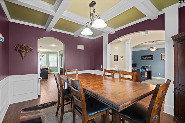 dining room with ceiling fan with notable chandelier, crown molding, coffered ceiling, and dark wood-type flooring