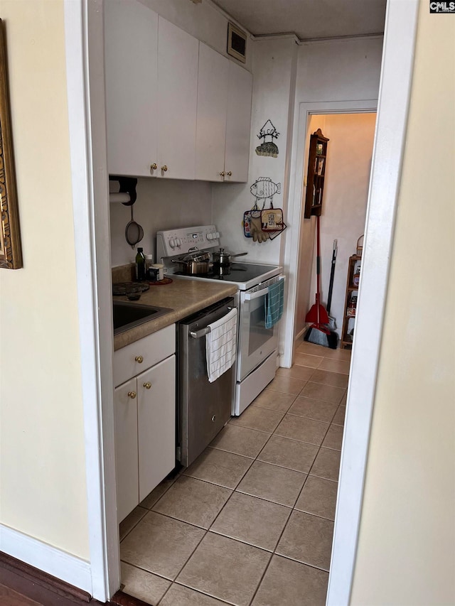 kitchen featuring range with electric stovetop, light tile patterned flooring, white cabinetry, dishwasher, and sink