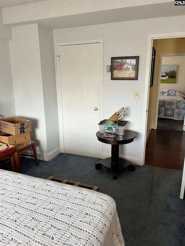 carpeted bedroom featuring a textured ceiling