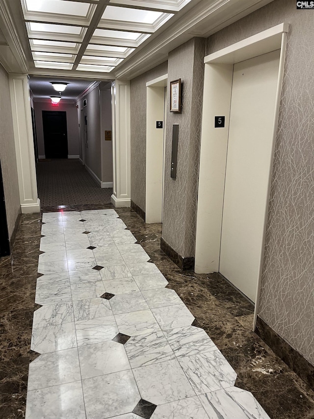 corridor featuring wallpapered walls, elevator, and marble finish floor