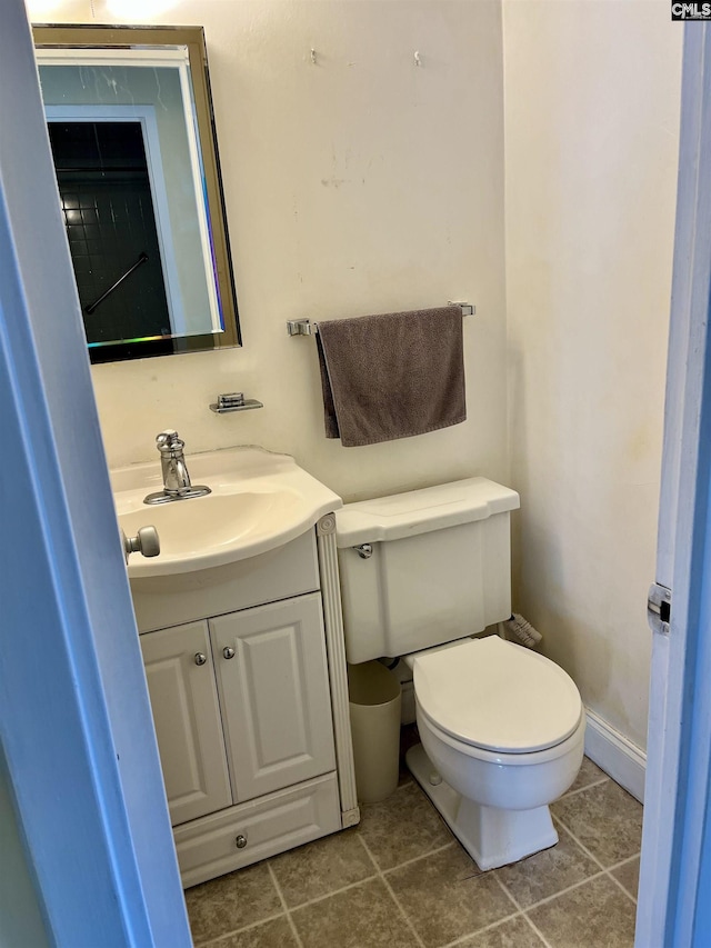 bathroom featuring vanity, toilet, and tile patterned flooring