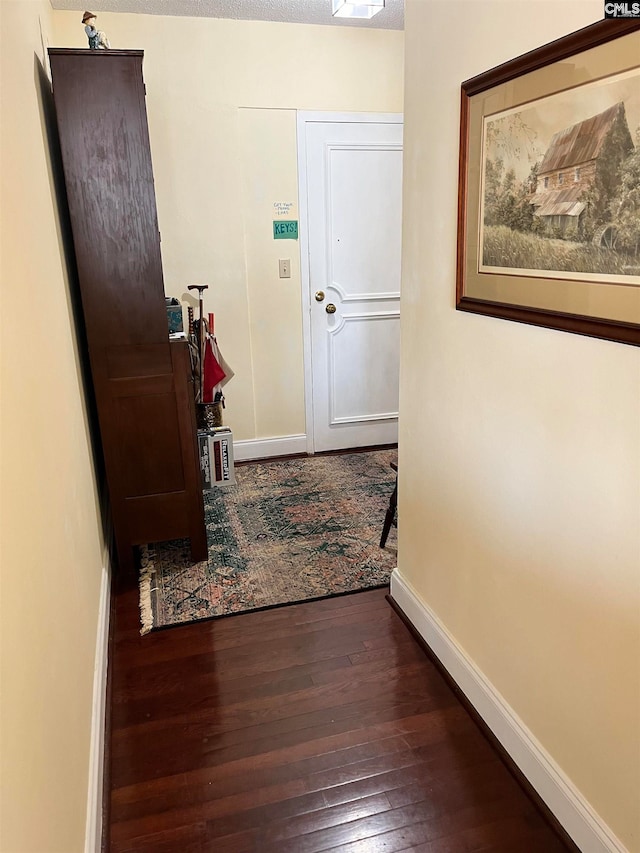 corridor featuring dark hardwood / wood-style flooring