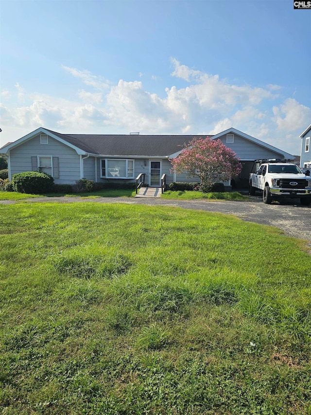 ranch-style home with a front yard