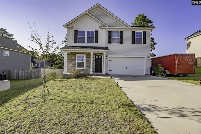 view of front of home featuring a front yard and a garage